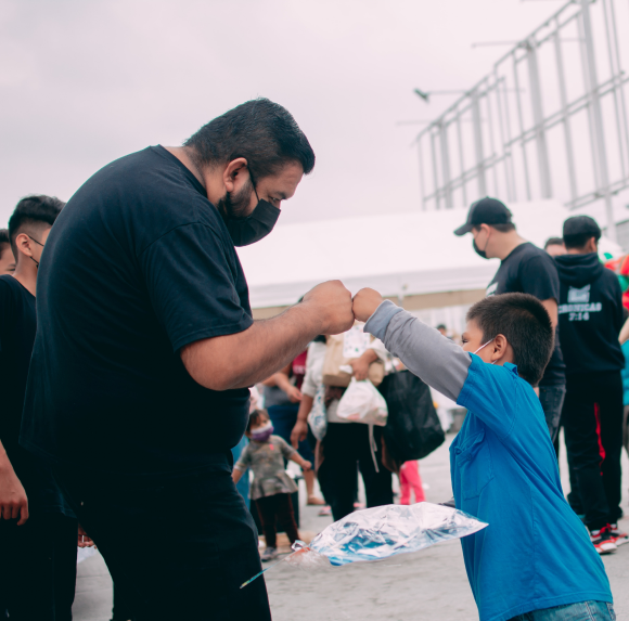 A man and a child fist bumping