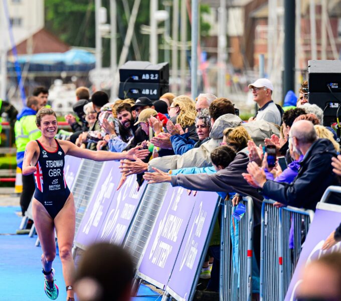 Lauren Steadman para-triathlete high-fiving crowd at Swansea race