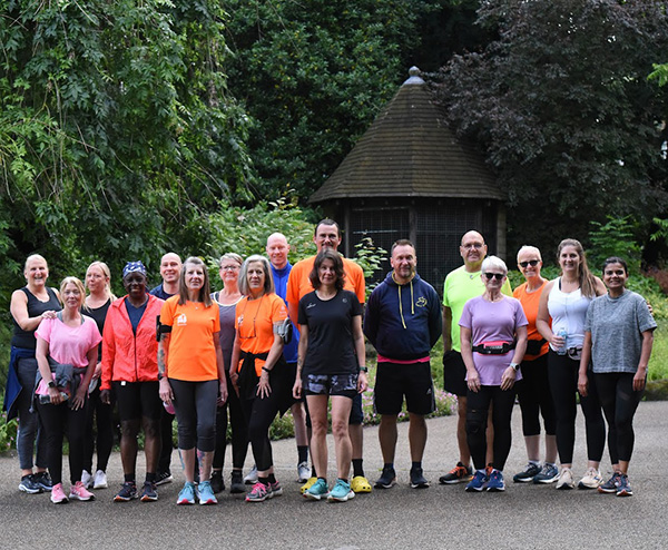 A group of 5k runners posing before a run