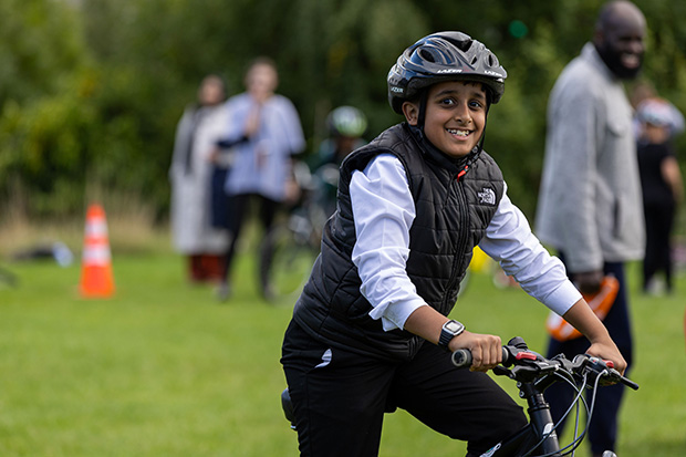 A child posing for a photo on a bike