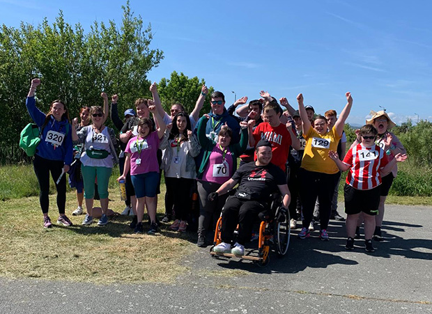 A group of people celebrating & posing for a photo