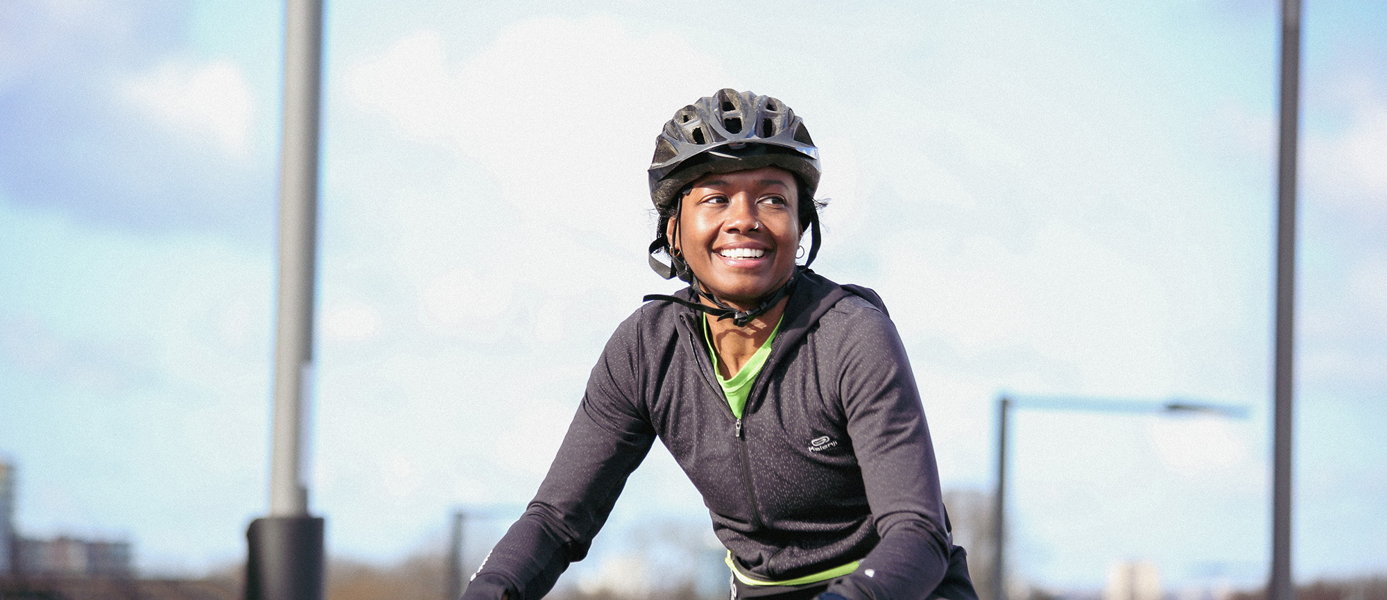 woman smiling on a bike