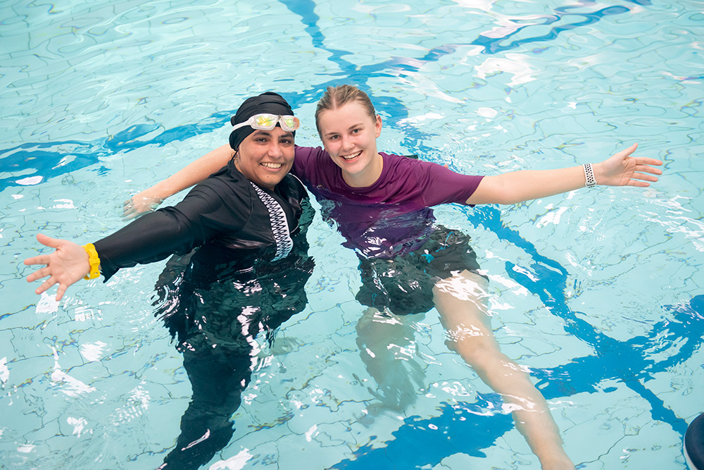 Two girls hugging in a pool