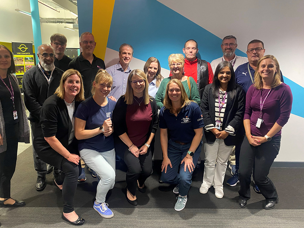 A group of co-workers posing for a photo